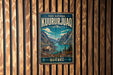 A vintage metal sign for the park national kuururjuaq in Quebec, featuring a scenic mountain landscape with a reindeer.