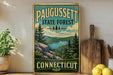 A vintage-style sign for Paugussett State Forest in Connecticut, featuring a scenic landscape with pine trees, a lake, and mountains.