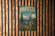 A vintage metal sign for the Payette National Forest in Idaho, featuring a scenic mountain landscape and text promoting the area's natural beauty and adventure opportunities.