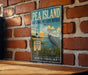 A vintage-style metal sign for Pea Island National Wildlife Refuge in North Carolina, featuring a lighthouse and a bird in the foreground.