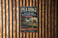 A vintage metal sign for Pea Ridge National Military Park in Arkansas, featuring an illustration of a cannon and a Union Jack flag.