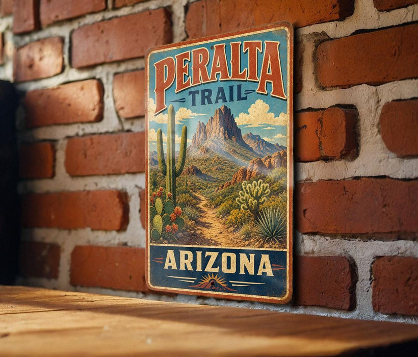 A vintage-style metal sign with a desert landscape and cacti, mounted on a brick wall.