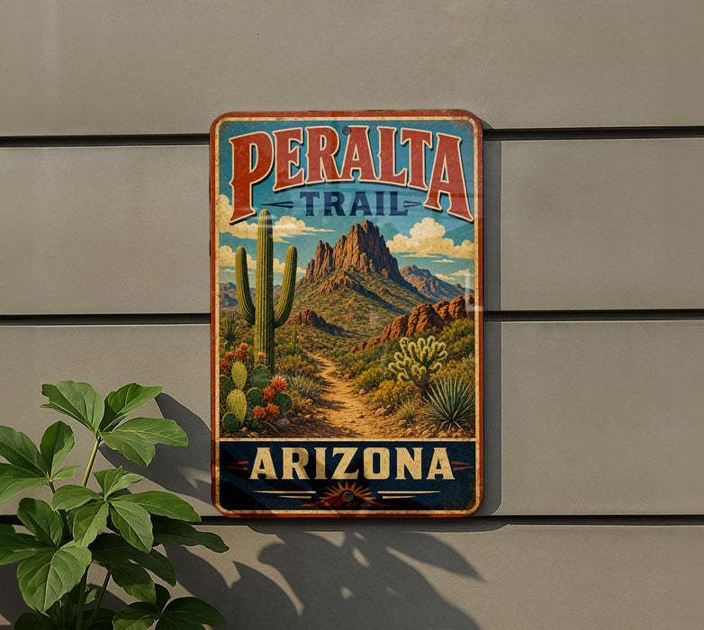 A vintage-style metal sign for the Peralta Trail in Arizona, featuring a desert landscape with mountains, cacti, and a dirt path.