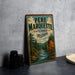 A vintage-style metal sign for the state forest in Michigan, featuring a scenic illustration of a river and autumn trees.