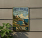 A vintage-style metal sign for the Petit Manan National Wildlife Refuge in Maine, featuring a puffin bird and a lighthouse on a rocky coastline.