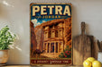 A vintage-style metal sign with the text "PETRA JORDAN" and an illustration of the ancient ruins of Petra, a famous landmark in Jordan.