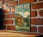 A vintage-style metal sign for the Pewits Nest State Natural Area in Wisconsin, featuring a scenic landscape with a river and forest.