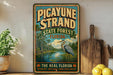 A vintage-style sign for the Picayune Strand State Forest in Florida, featuring a large blue heron in the foreground and a lush, tropical landscape in the background.