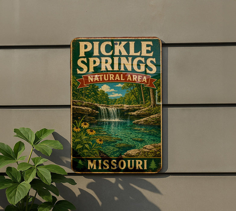 A vintage metal sign for Pickle Springs Natural Area in Missouri, featuring a scenic landscape with a waterfall and lush greenery.