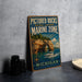 A vintage-style sign for the Pictured Rocks National Lakeshore Marine Zone in Michigan, featuring a scenic image of a boat on the water and a rocky arch in the background.