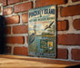 A vintage-style metal sign for Pinchney Island National Wildlife Refuge in South Carolina, featuring an illustration of a bird and a body of water.