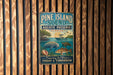 A vintage-style metal sign for Pine Island Sound Aquatic Preserve in Florida, featuring illustrations of various marine life and a boat on the water.