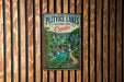 A vintage metal sign for Plitvice Lakes National Park in Croatia, featuring a scenic landscape with waterfalls and lush greenery.