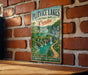 A vintage-style metal sign for Plitvice Lakes National Park in Croatia, featuring a scenic landscape with waterfalls and lush greenery.