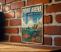 A vintage metal sign for Point Arena, a State Marine Reserve in California, featuring a lighthouse and ocean scene.