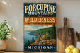 A vintage-style sign for Porcupine Mountain State Park in Michigan, featuring a scenic mountain landscape with pine trees and a lake.