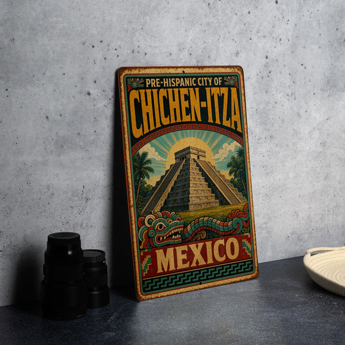 A vintage-style metal sign with the text "PRE-HISPANIC CITY OF CHICHEN-ITZA MEXICO" and an illustration of a pyramid and a dragon, indicating the location of the Pre-Historic City of Chichen-Itza in Mexico.