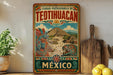 a colorful poster of Teotihuacan, an ancient Mesoamerican city, displayed on a wall.