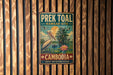 A vintage metal sign with a bird illustration and text, mounted on a wooden wall.