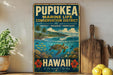 A vintage metal sign with a tropical beach scene and a sea turtle, promoting the Pupukea Marine Life Conservation District in Hawaii.