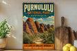 a vintage-style poster of the Purnululu National Park in Australia, with a scenic illustration of the unique rock formations. The poster is displayed on a wall, surrounded by various kitchen items such as a cutting board, a knife, a spoon, and a bowl.