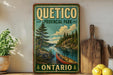 A vintage-style sign for Quito Provincial Park in Ontario, featuring a canoe on a river surrounded by pine trees and a cloudy sky.