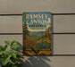 A vintage metal sign for Ramsey Canyon Preserve in Arizona, featuring a scenic landscape with mountains, flowers, and a desert backdrop.