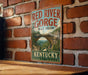 A vintage-style sign for the Red River Gorge Trail System in Kentucky, featuring a scenic illustration of the gorge and a bridge.