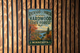 A vintage metal sign for the Richard J. Domer Memorial Hardwood State Forest in Minnesota, featuring a scenic landscape with a lake and autumn foliage.