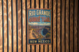 A vintage-style metal sign for the Rio Grande Gorge Trail in New Mexico, featuring a scenic illustration of the Grand Canyon.