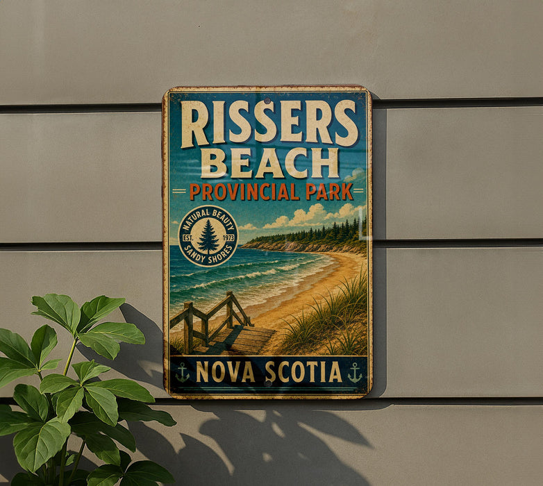 A vintage-style metal sign for Rissers Beach, a coastal park in Nova Scotia, Canada.