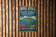 A vintage-style metal sign for Rose Atoll Marine National Monument, featuring an illustration of a tropical island, sea turtle, and coral reef.