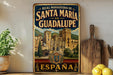 A vintage-style metal sign advertising "Santa Maria de Guadalupe" in España, featuring an illustration of a castle and mountains.