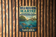 a vintage metal sign with a tropical beach scene, including a bird, a boat, and a turtle, hanging on a wooden wall.