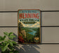 A vintage-style metal sign for Ruth and Paul Henning State Forest in Missouri, featuring a scenic landscape with a river, mountains, and pine trees.