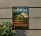 a vintage-style sign for Sagamore Hill, New York, with a large house and trees in the background.