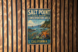 A vintage metal sign for the Salt Point State Marine Conservation Area in California, featuring a scenic coastal landscape with a starfish and other marine life.