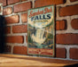 A vintage-style sign for Samboo Deh Falls, a waterfall located in Northwest Territories, Canada.