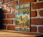 A vintage-style sign for San Antonio Missions National Historical Park, featuring an illustration of the Mission San Antonio and the surrounding landscape.