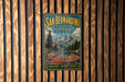 A vintage-style metal sign for the San Bernardino National Forest in California, featuring a scenic mountain landscape and the text "California" and "Adventure - Discover - Explore".