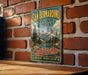 A vintage-style metal sign for the San Bernardino National Forest in California, featuring a scenic mountain landscape and the text "San Bernardino National Forest" and "California".