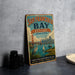 A vintage-style metal sign for San Francisco Bay Estuary, featuring a cityscape, a crane, and a crane in the background.