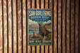 A vintage metal sign for San Guillermo Biosphere Reserve in Argentina, featuring a seal and mountains in the background.