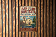 A vintage metal sign for San Juan Bautista State Historic Park, featuring a church and a sign that says "Step back in time where California history began".