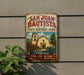 A vintage-style metal sign for San Juan Bautista State Historic Park, featuring an illustration of a historic building and surrounded by a lush green plant.
