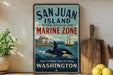 A vintage-style sign for San Juan Island National Historical Park, featuring an illustration of a whale, a lighthouse, and a ship, along with the text "San Juan Island Marine Zone Washington".