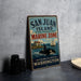 A vintage-style sign for San Juan Island National Historical Park's Marine Zone, featuring an illustration of a whale and a sailboat, along with the text "San Juan Island Marine Zone" and "Explore Our Waters, Protect Our Heritage".