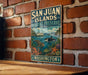 A vintage-style metal sign for the San Juan Islands Marine Preserve in Washington, featuring illustrations of marine life and a boat on the water.