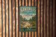 A vintage metal sign for the Sand Hills State Forest in South Carolina, featuring a scenic illustration of a forest trail.