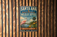 A vintage-style metal sign for Santa Ana National Wildlife Refuge in Texas, featuring a pink flamingo and a scenic landscape.